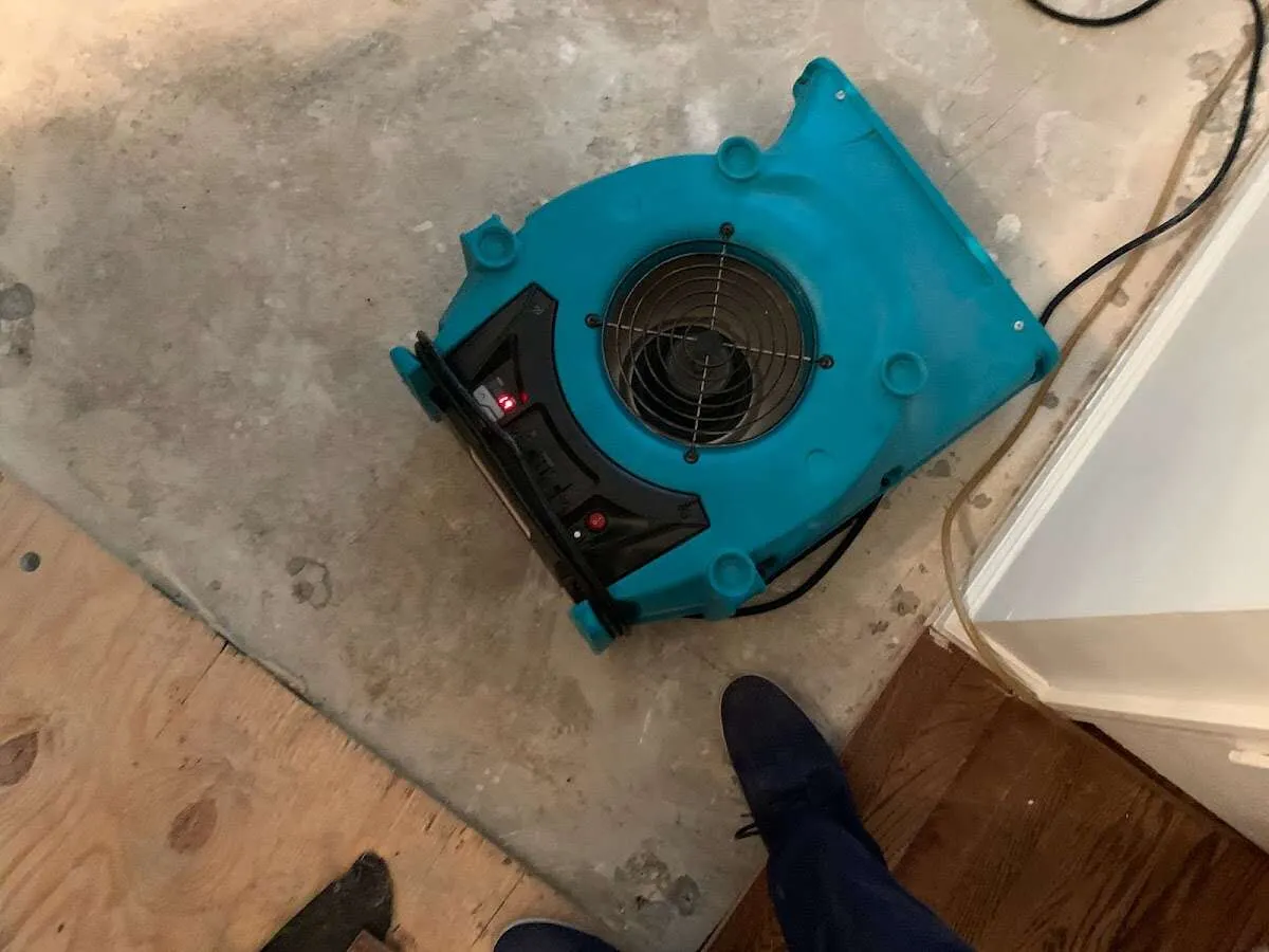 Air mover drying subfloor during Leak Detection & Repair in Poteau